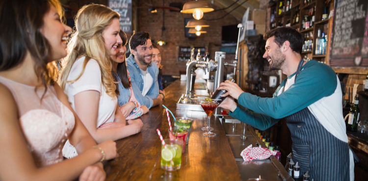 Bartender interacting with customers. Bartender interacting with customers.
