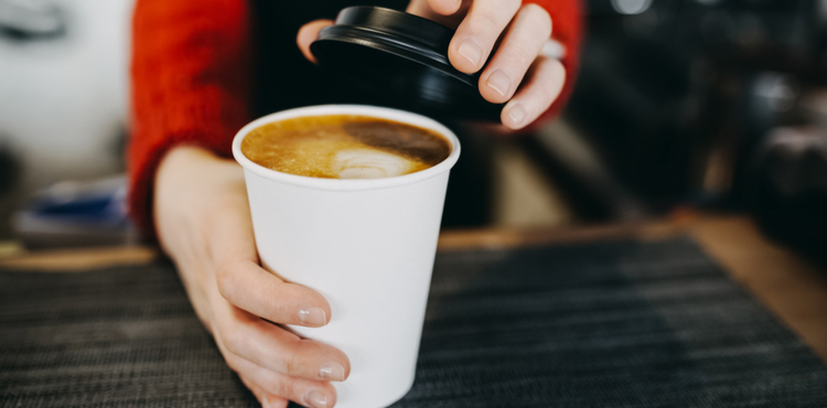 Hot cup of coffee in a to-go cup. Hot cup of coffee in a to-go cup.