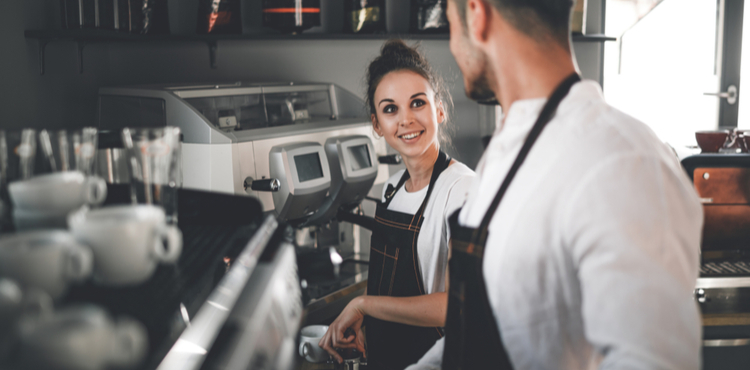 Two employees in a coffee shop. Two employees in a coffee shop.