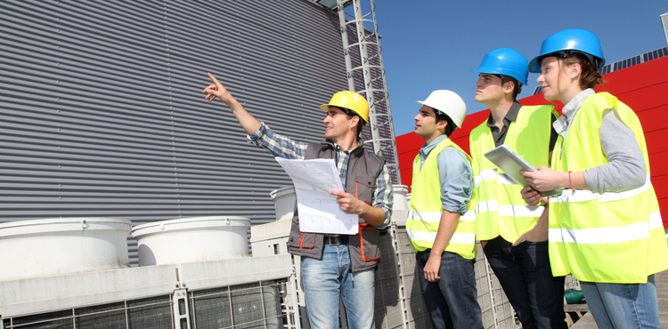 A group of construction workers on a job site. A group of construction workers on a job site.