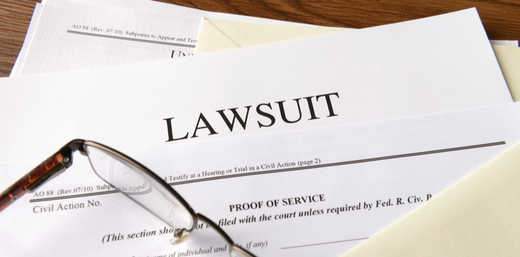 Glasses on top of lawsuit filings. Glasses on top of lawsuit filings.