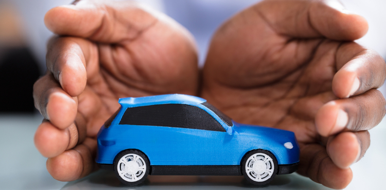 Hands cupped around a toy car. Hands cupped around a toy car.