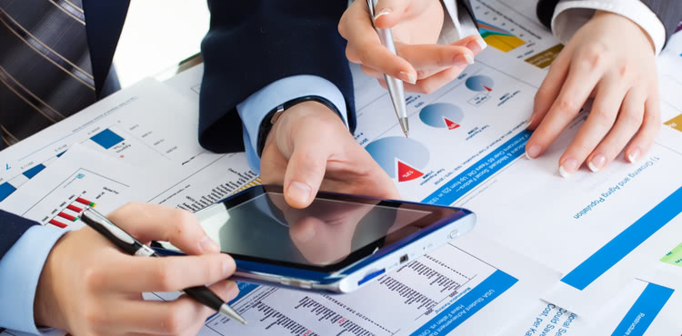 Man and woman working with graphs and smartphone. Man and woman working with graphs and smartphone.