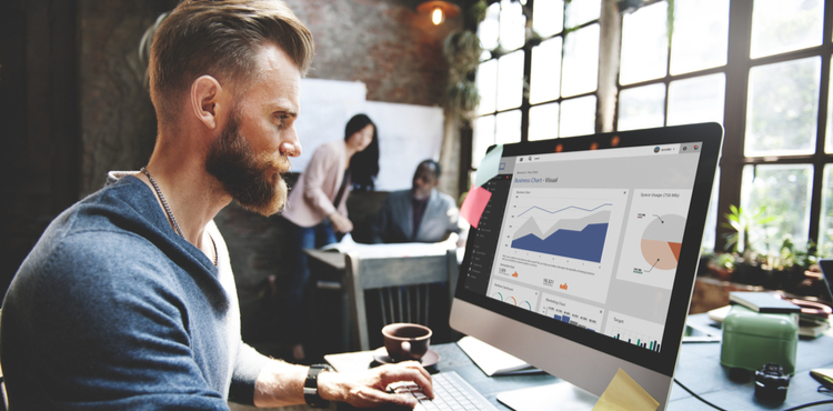 Man reviewing marketing data on a computer. Man reviewing marketing data on a computer.