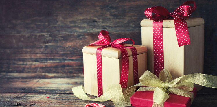Three holiday gifts with a wooden background. Three holiday gifts with a wooden background.