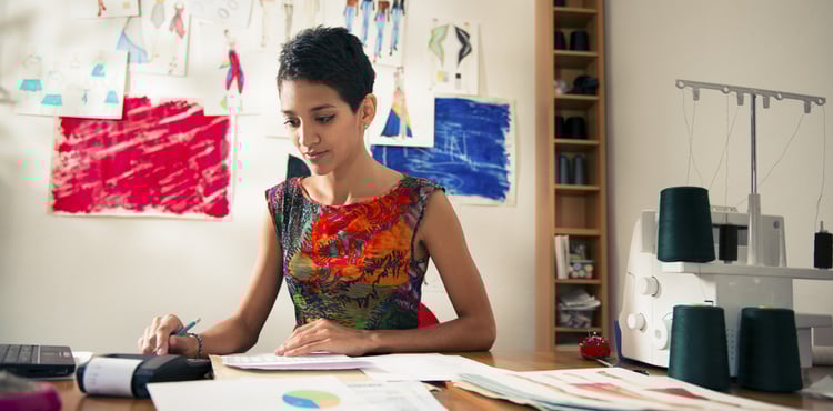A young woman performing calculations in an office. A young woman performing calculations in an office.