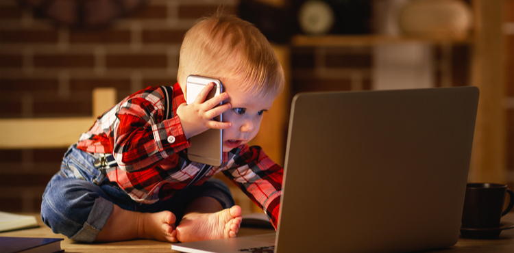 Baby pretending to work on a phone and laptop. Baby pretending to work on a phone and laptop.