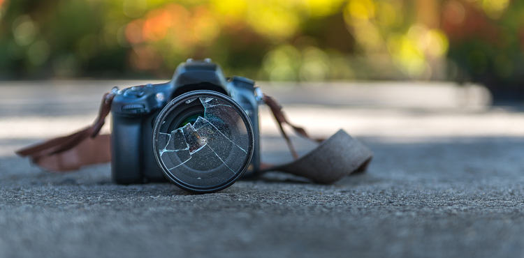 Broken camera on the floor. Broken camera on the floor.