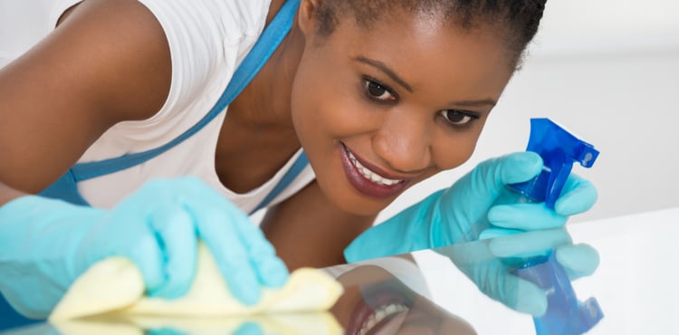Close up of woman cleaning a surface with gloves on. Close up of woman cleaning a surface with gloves on.