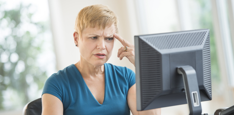 Woman at computer looking confused. Woman at computer looking confused.