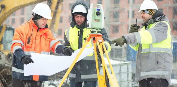 Construction workers discuss plans during snowstorm. Construction workers discuss plans during snowstorm.