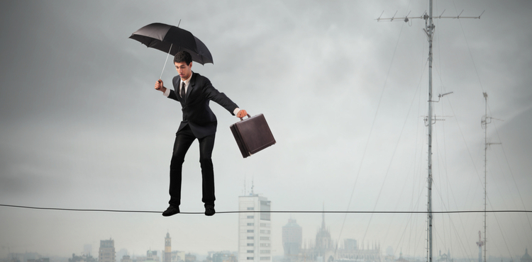 Man balancing on a tightrope with an umbrella and a briefcase. Man balancing on a tightrope with an umbrella and a briefcase.