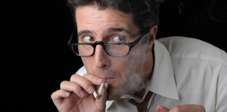 Businessman sneaking a smoke of marijuana. Businessman sneaking a smoke of marijuana.
