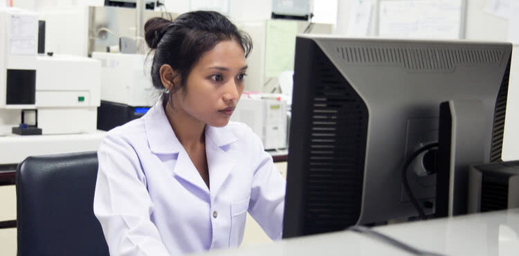 Nurse sitting at a computer. Nurse sitting at a computer.