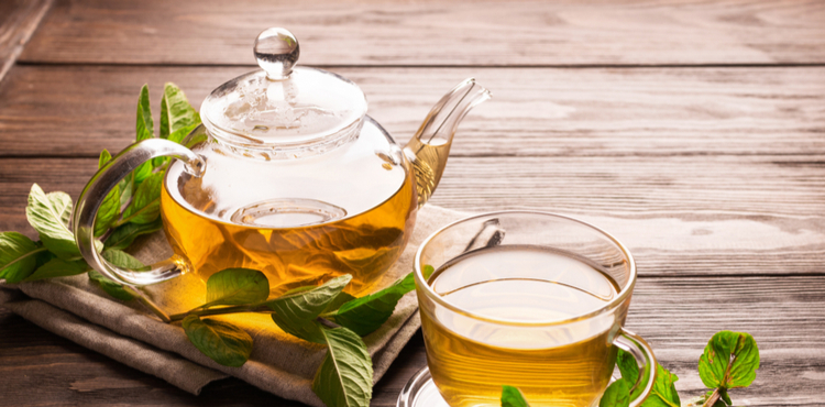 Glass teapot and teacup with mint tea. Glass teapot and teacup with mint tea.