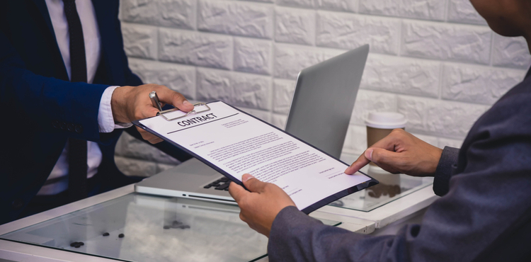 Two business men discuss and sign contract. Two business men discuss and sign contract.