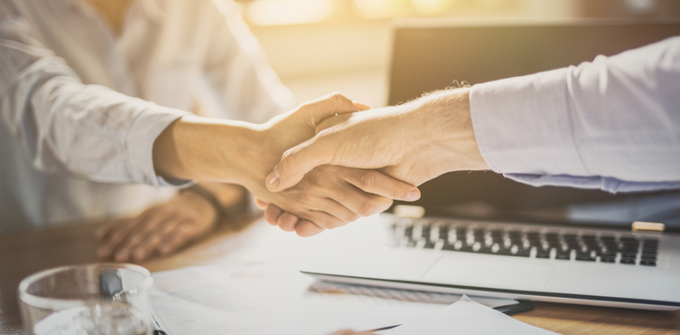 Two people shaking hands. Two people shaking hands.