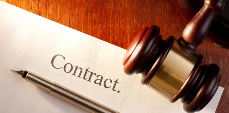 Pen and gavel on a contract. Pen and gavel on a contract.