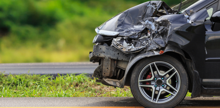 The damaged front end of a car. The damaged front end of a car.