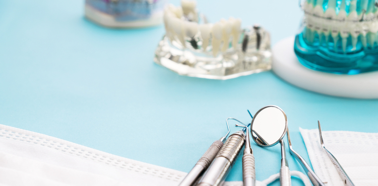 Dental tools on a blue surface. Dental tools on a blue surface.