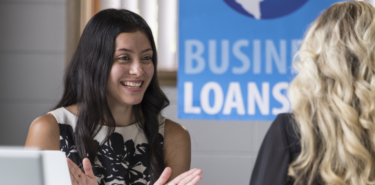 A female business loan worker talking to another woman. A female business loan worker talking to another woman.