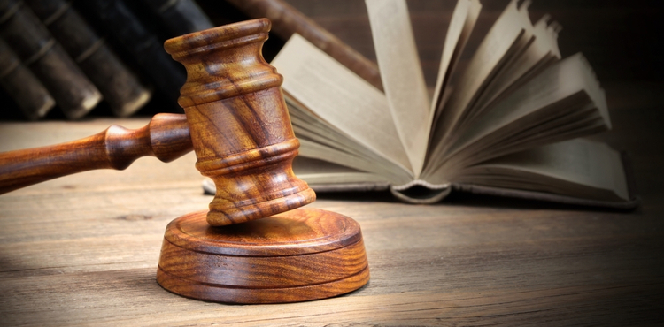 A gavel and an open book. A gavel and an open book.