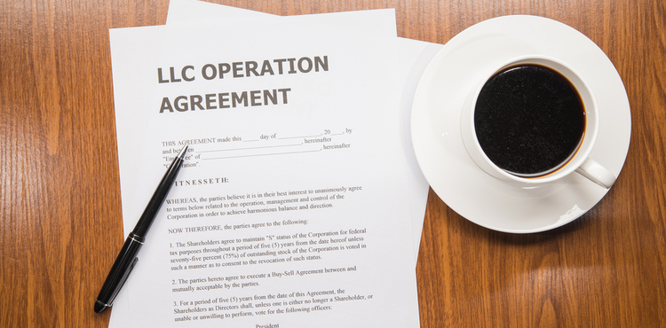 An LLC operation agreement and a cup of coffee. An LLC operation agreement and a cup of coffee.