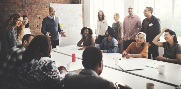 A staff meeting in a conference room. A staff meeting in a conference room.