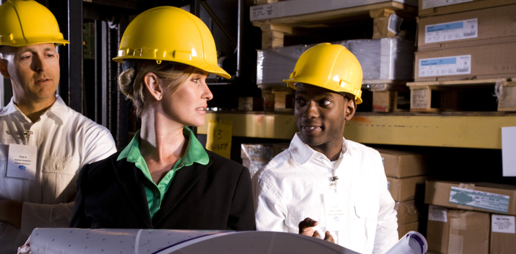 Three people wearing construction hats. Three people wearing construction hats.