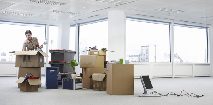 A businesswoman unpacking stuff for an office. A businesswoman unpacking stuff for an office.
