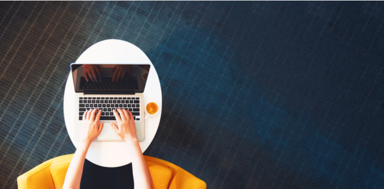A view from above a woman working on a laptop. A view from above a woman working on a laptop.