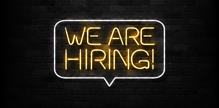 Neon sign that says 'we are hiring'. Neon sign that says 'we are hiring'.