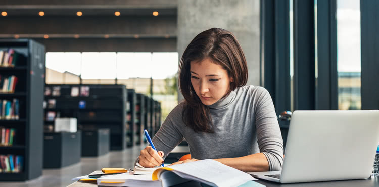 Woman doing research at a library. Woman doing research at a library.