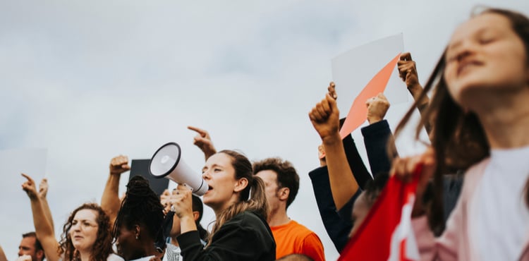 A group of activists protesting with signs. A group of activists protesting with signs.