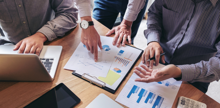 Business men discuss reports in strategy meeting. Business men discuss reports in strategy meeting.