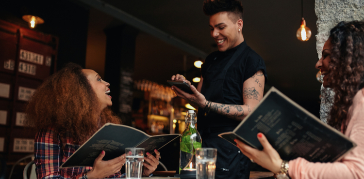 Diners ordering from menu. Diners ordering from menu.