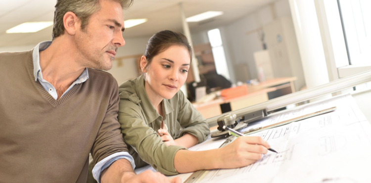 Two architects work together on a building design. Two architects work together on a building design.