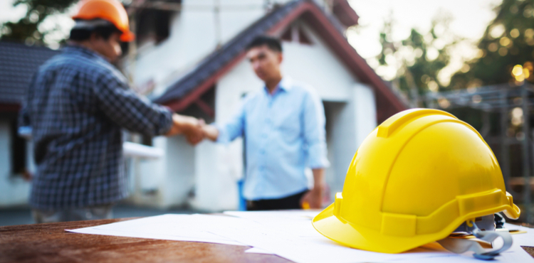 Two contractors shaking hands. Two contractors shaking hands.