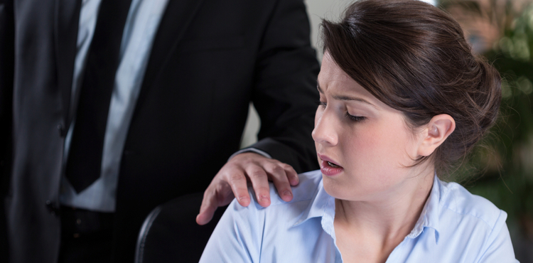 A woman looking uncomfortable as a man in a suit places his hand on her shoulder. A woman looking uncomfortable as a man in a suit places his hand on her shoulder.