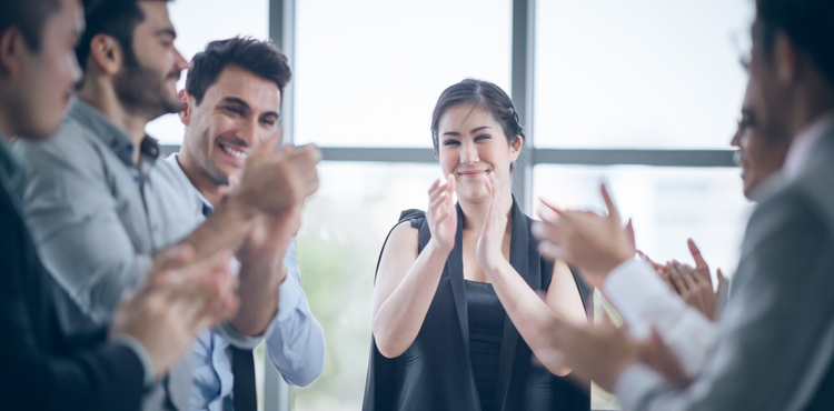 Colleagues celebrate success in the office with a round of applause. Colleagues celebrate success in the office with a round of applause.