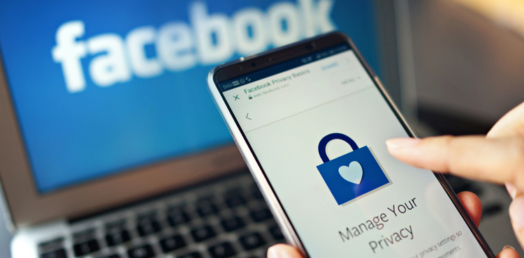 Laptop with Facebook logo and a cell phone showing privacy settings. Laptop with Facebook logo and a cell phone showing privacy settings.