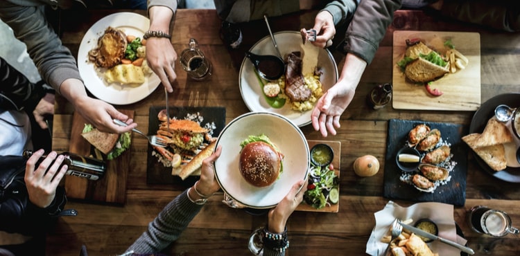 Plates of food on a table in a restaurant from above. Plates of food on a table in a restaurant from above.