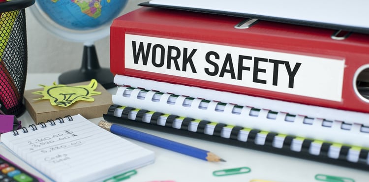 A work safety notebook on an office desk. A work safety notebook on an office desk.