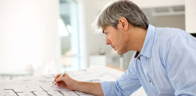 An architect at a drawing table An architect at a drawing table
