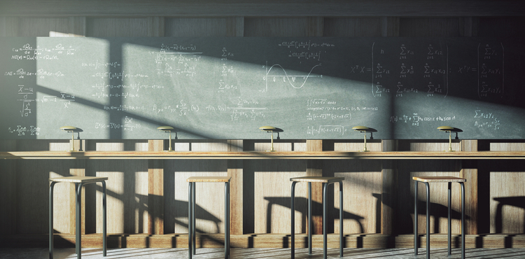 An empty classroom with a blackboard.
