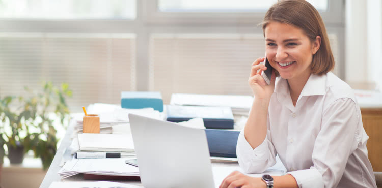 IT consultant on a phone call with a client. IT consultant on a phone call with a client.