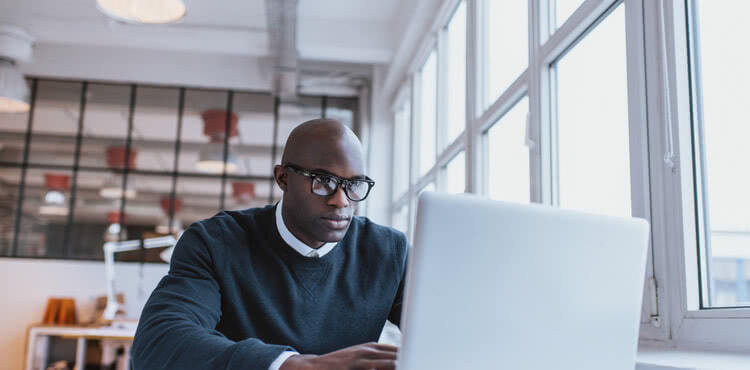 A serious man using a laptop A serious man using a laptop