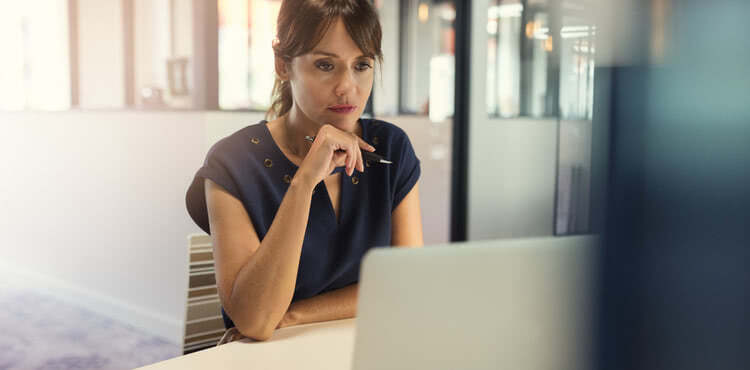 A serious woman looking at a laptop A serious woman looking at a laptop