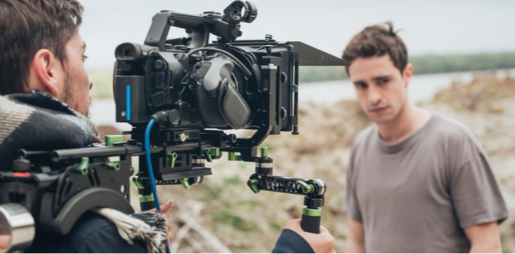 Two young men filming outdoors. Two young men filming outdoors.