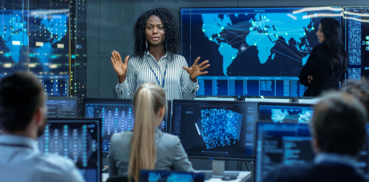 A woman giving a presentation in front of a map of the world. A woman giving a presentation in front of a map of the world.